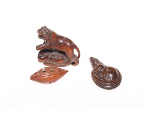 Two Japanese carved wood netsuke and coquilla nut carved as a boat (3).