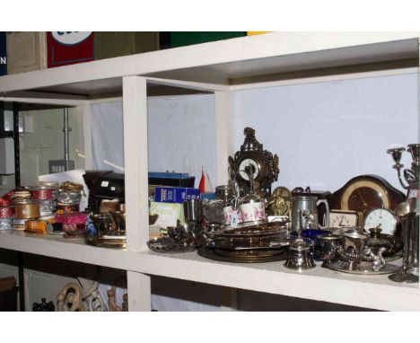 Shelf of cameras, metal wares, mantel clocks, Wade, binoculars, cutlery, glass.