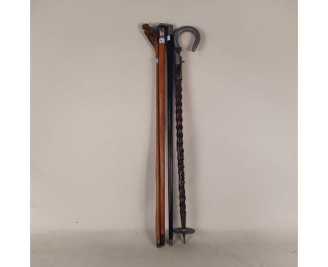 A vintage shooting stick plus three walking canes, one with silver hallmarked collar, agate stone to handle, one with carved 