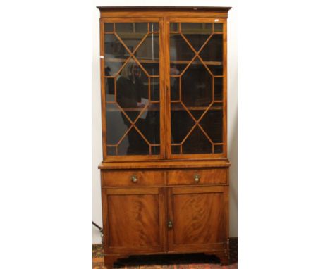 Edwardian mahogany bookcase with astragal glazed doors above two drawers and two cupboard doors, on bracket feet, 214cm high 