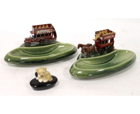 Pair of Wade advertising coach ashtrays for 'Dewars' and 'Liptons Tea', each surmounted by a die cast model of a horse drawn 