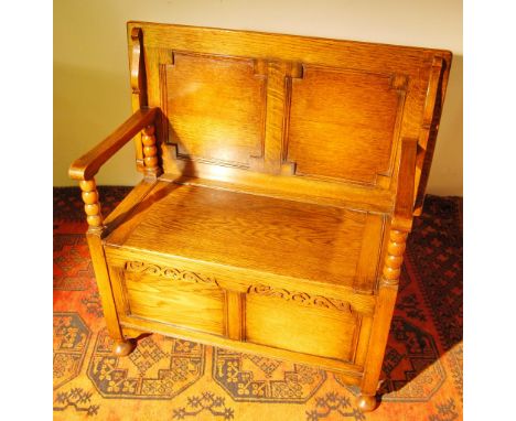 Early 20th century oak monk's bench with folding top and seat compartment, 93cm high and 91cm wide.