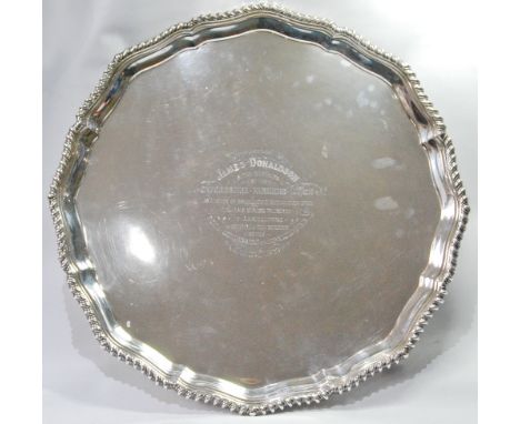 Silver circular tray with shaped, moulded and gadrooned border on reeded scroll feet, 'James Donaldson...Oxfordshire Farmer's