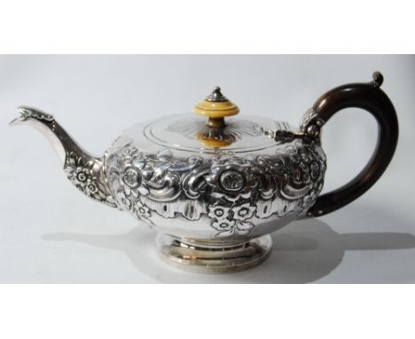 Silver teapot of compressed spherical form with embossed flowers and scrolls, on moulded foot, by R. Hennell, 1830, 17oz.