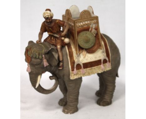 Royal Dux porcelain figure of a Nubian atop an elephant with howdah, triangle pink patch mark, impressed E, 26cm high.