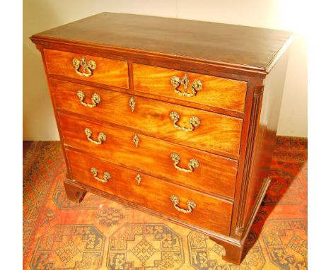 George III mahogany chest with fluted quarter columns flanking two short and three long drawers, on bracket feet, 94cm high a