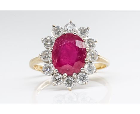 A RUBY AND DIAMOND CLUSTER RINGFeaturing a central oval faceted ruby (weight 3.50 carats) with a surround of twelve round bri