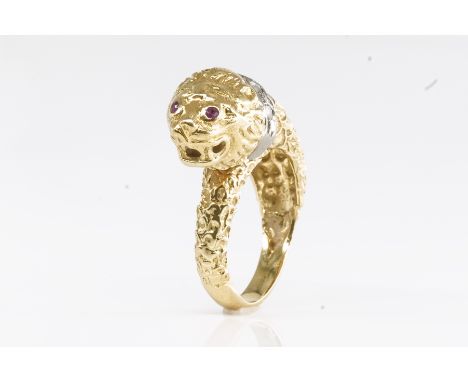 A DIAMOND AND RUBY LION RINGIn the form of a lion, with ruby set eyes and rose cut diamond set collar, stamped 750, ring size