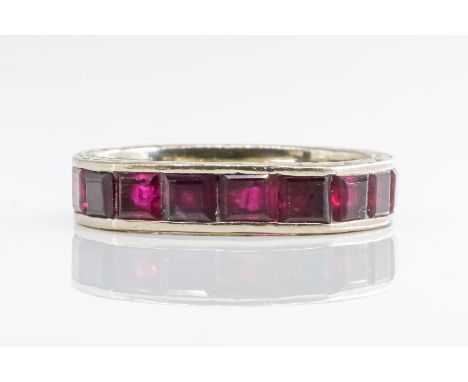 AN ART DECO RUBY FULL ETERNITY RINGSet with square cut rubies, in a channel setting, with engraving to the side of the band, 