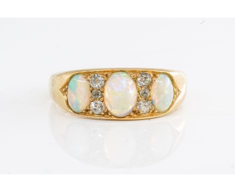A VICTORIAN OPAL AND DIAMOND RINGSet with three oval cabochon opals and six old mine cut diamonds, in 18ct yellow gold, ring 