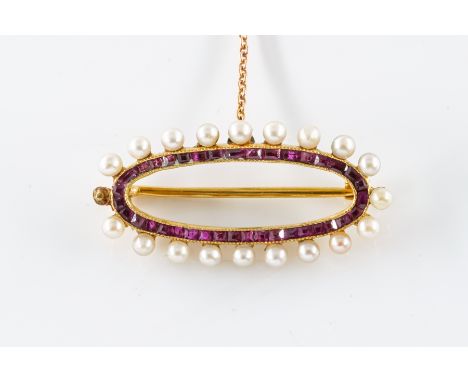 A RUBY AND SEED PEARL BROOCHSet with calibre cut rubies creating an oval form, with mille grain edge detailing and with pearl