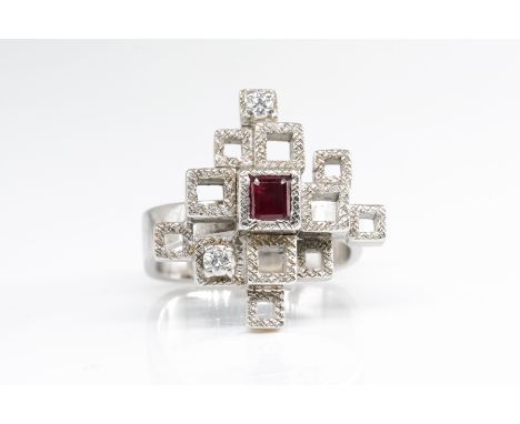 AN ANDREW GRIMA RUBY AND DIAMOND RINGMounted with a square cut ruby and with two circular cut diamonds, in an abstract design