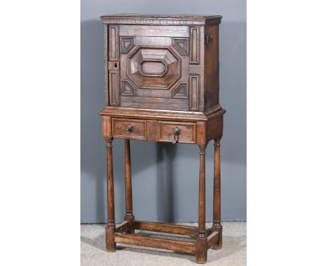 A 17th Century Oak Spice Cupboard, the interior fitted ten small drawers enclosed by one single raised and moulded panel door