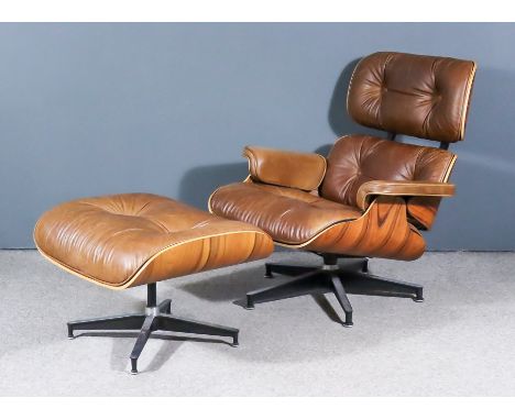 After Ray and Charles Eames - Modern Veneered Wood and Black Metal Framed Lounge Chair, (No.670), and Ottoman (No. 671), the 