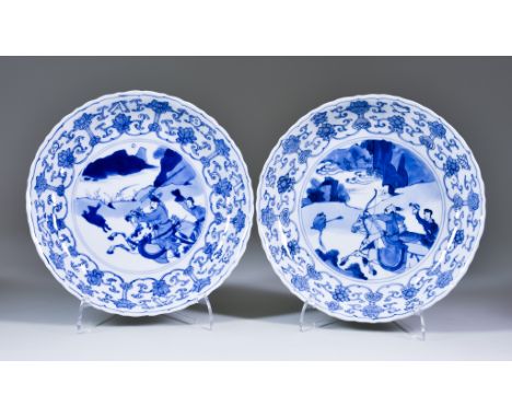 Two Chinese Kangxi Blue and White Porcelain Plates, painted with hunting scenes within floral and scroll borders, 8ins (20.3c