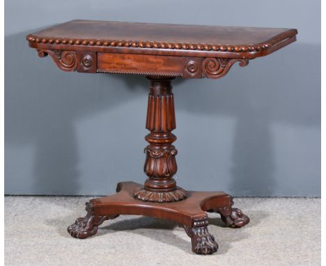 A William IV Mahogany Rectangular Card Table, the figured veneered baize lined folding top with carved gadroon edges and roun