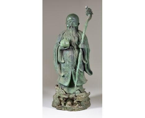 A Chinese Bronze Figure of Shou-Lao, Daoist God of Longevity, holding a dragon staff and peach, 19.5ins (49.5cm) highConditio