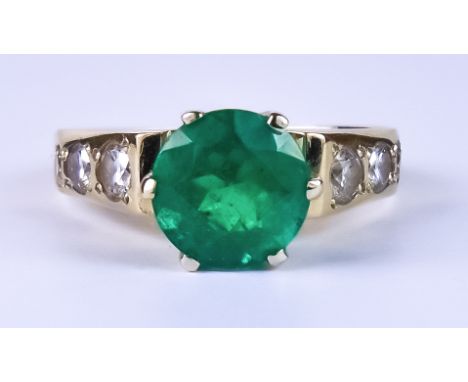 An Emerald and Diamond Ring, Modern, 14ct gold set with a centre emerald, approximately 1.50ct, flanked either side by three 