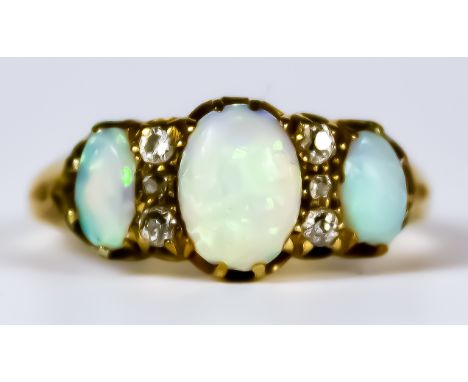 An Opal and Sapphire Ring, 20th Century, 18ct gold set with three opals inter spaced with four small white sapphires, size R,