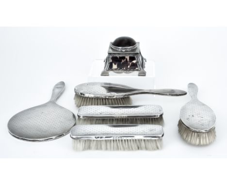 A George V Silver Mounted and Tortoiseshell Inkwell and a Five-Piece Silver Backed Dressing Table Set, the inkwell by J Basto