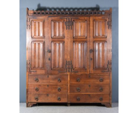 A 19th Century Panelled Oak and Wrought Iron Hall Cupboard, of Gothic form, with carved quatrefoil pediment, fitted four shel