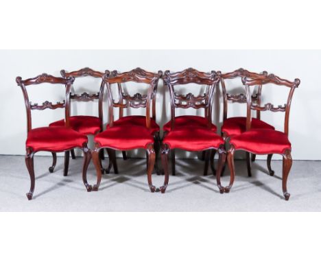 A Set of Six Victorian Mahogany Dining Chairs and Two Others of Later Date, each with shaped and moulded crest rails and spla