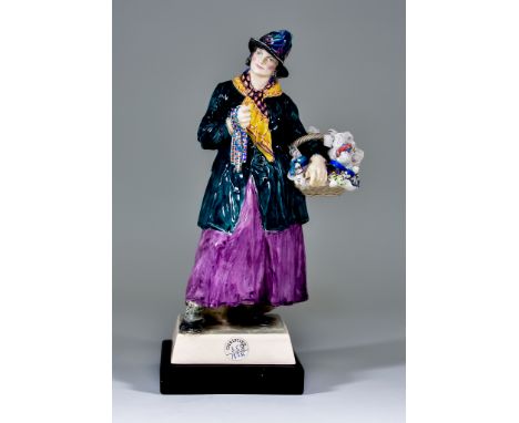 A Charles Vyse Pottery Figure - "The Pedlar", circa 1926, modelled as a standing lady holding strings of beads in her right h