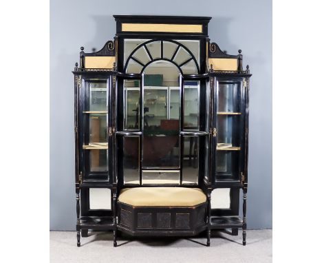 A Late Victorian Ebonised and Parcel Gilt Wall Unit in the 'Aesthetic' Manner, the central section with shaped cornice and in