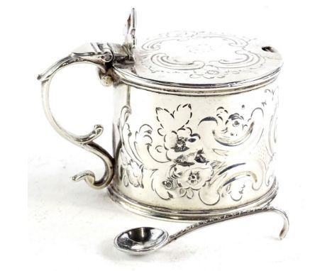 A Victorian drum shaped silver mustard pot, the hinged lid engraved to the top with a cartouche and indistinct initials, with