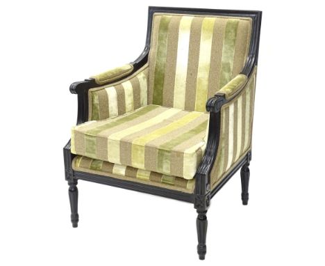 A Continental ebonised armchair, upholstered in striped fabric, on turned and fluted legs.Provenance: The property of Joan St