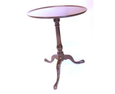 A George III mahogany occasional table, the circular dished tilting top with a turned column and tripod base with pad feet, 5