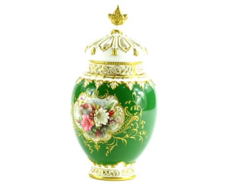 A Royal Worcester porcelain pot pourri jar cover, painted with a flower spray, on a green ground with gilt decoration, printe