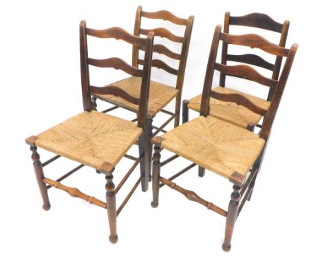 An associated set of four 19thC country made oak and ash ladder back chairs, each with a rush seat on turned legs.Provenance: