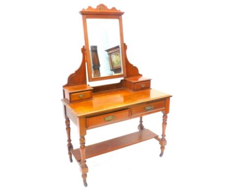 A late Victorian walnut dressing table, the top with a bevelled mirror plate on shaped supports with small trinket drawers, t