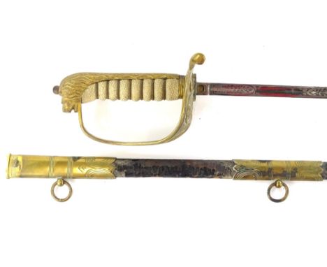 An early 20thC naval dress sword, the leather scabbard with engraved brass mounts, the blade stamped Gieves &amp; Co with anc