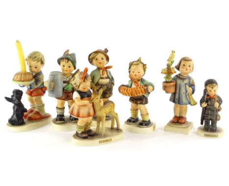 A collection of seven Hummel figures, modelled in the form of children with animals, flowers etc., to include a candlestick f