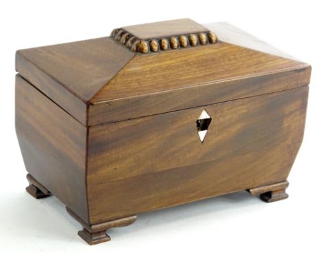 A Victorian mahogany sarcophagus shaped tea caddy, the hinged lid enclosing a relined interior, on ogee bracket feet, 19cm W.