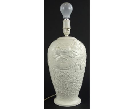 A Bretby pottery lamp base, moulded in relief with oriental dragon etc., impressed mark to underside, 48cm H including fittin