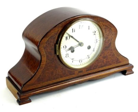 A mahogany and amboyna cased mantel clock, with a silvered dial on ogee bracket feet, 41cm W.