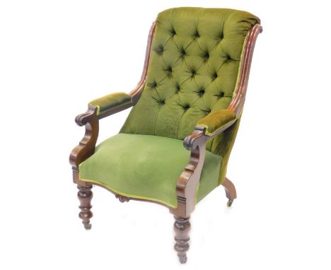 A Victorian mahogany open armchair, with a green buttoned upholstered back, pillared arms and seat, the carved arm rest on sh