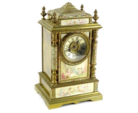 An early 20thC French gilt brass and champleve enamel mantel clock, the silvered dial with Roman numerals, the case mounted w