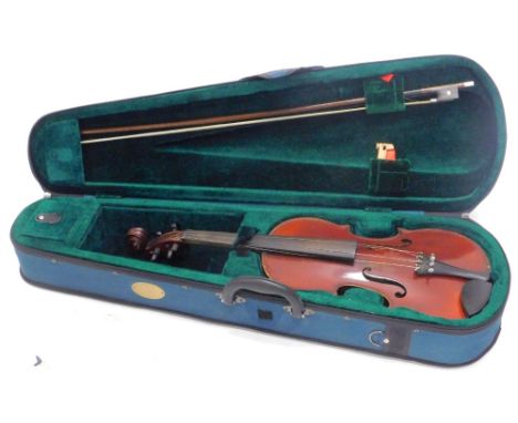 A violin, with two piece back, labelled Medio Fine, length of back 36cm and a violin bow.