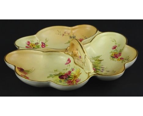 A Royal Worcester triple hors d'oeuvres dish, with a single handle painted with flower spray on a blush ivory ground, printed