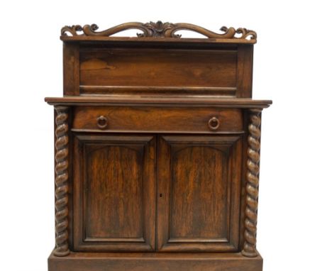 A William IV rosewood chiffonier, with scroll and open carved raised panel back with shelf, 'D' fronted frieze drawer over tw