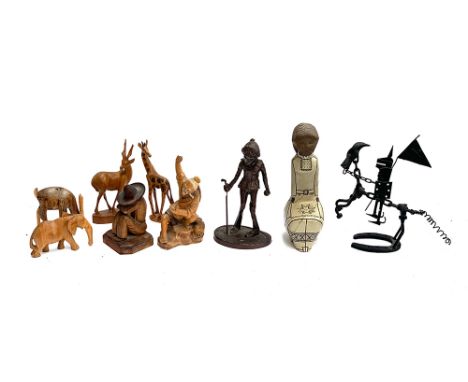 A lot of various figures to include carved wooden animals, carved Chinese fisherman, abstract wrought metal sculpture of a kn