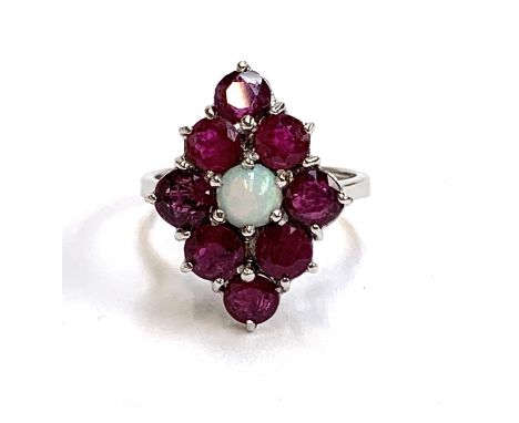 A 9ct white gold ring set with a navette form cluster of rubies and a central opal, size J, 3.2g 