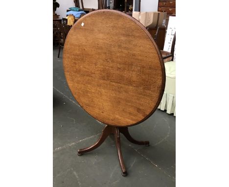 An early 20th century oak tip top tripod table, on four swept legs, 92x72cmH 