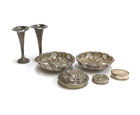 A pair of hallmarked silver chased and pierced bonbon dishes; two chased silver lids; silver napkin ring, 4.7ozt; together wi