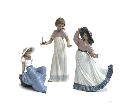 Three Nao by Lladro figures, girl holding candle, no. 1155, 26cmH, girl posing, no. 1391, girl lounging on rock, no. 1042, to
