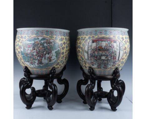 Pair of large Chinese fish bowls traditionally decorated with polychrome enamel depicting scholars scenes in cartouche panels